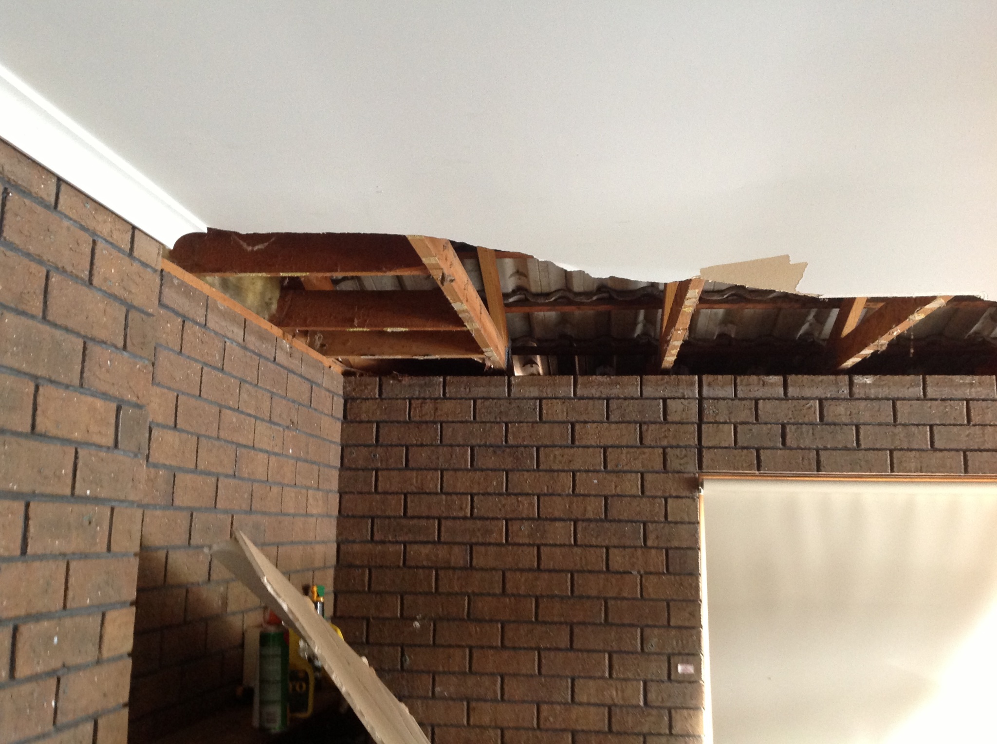 Collapsed water-damaged ceiling exposing roof structure
